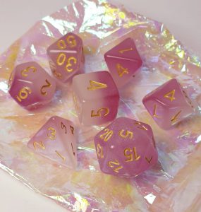 Glow in the dark pink and white polyhedral dungeons and dragons dice set
