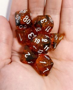 Orange and glitter dungeons and dragons polyhedral dice set