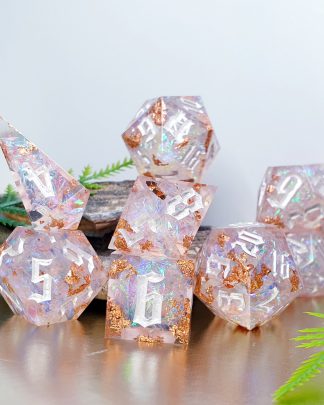 soft pink with rose gold foil and iridescent inclusions sharp edge handmade polyhedral dungeons and dragons dice set