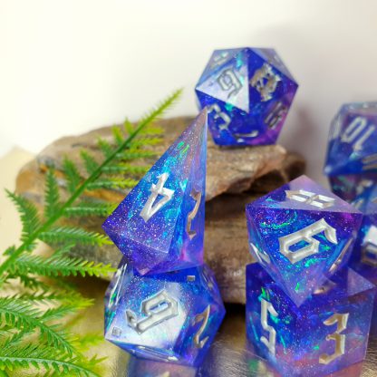 Purple blue and pink resin with glitter and iridescent inclusions sharp edge handmade polyhedral dungeons and dragons dice set